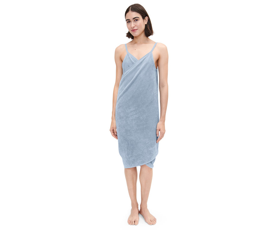 Frau steht und trägt ein hellblaues Handtuch-Kleid.