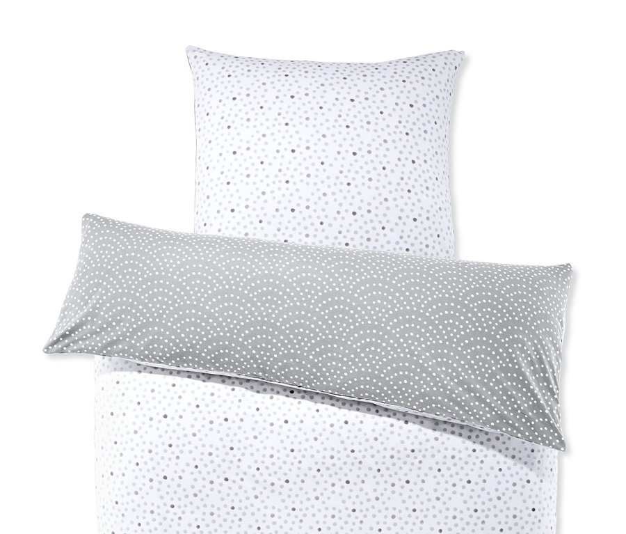 Weiße Bettwäsche mit Punktmuster und grauem Kissen. Jersey-Wendebettwäsche, Normalgröße.