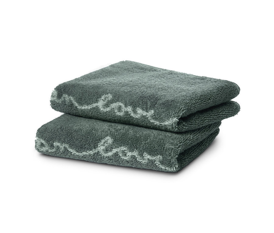 Zwei Jacquard-Gästehandtücher liegen gefaltet aufeinander.