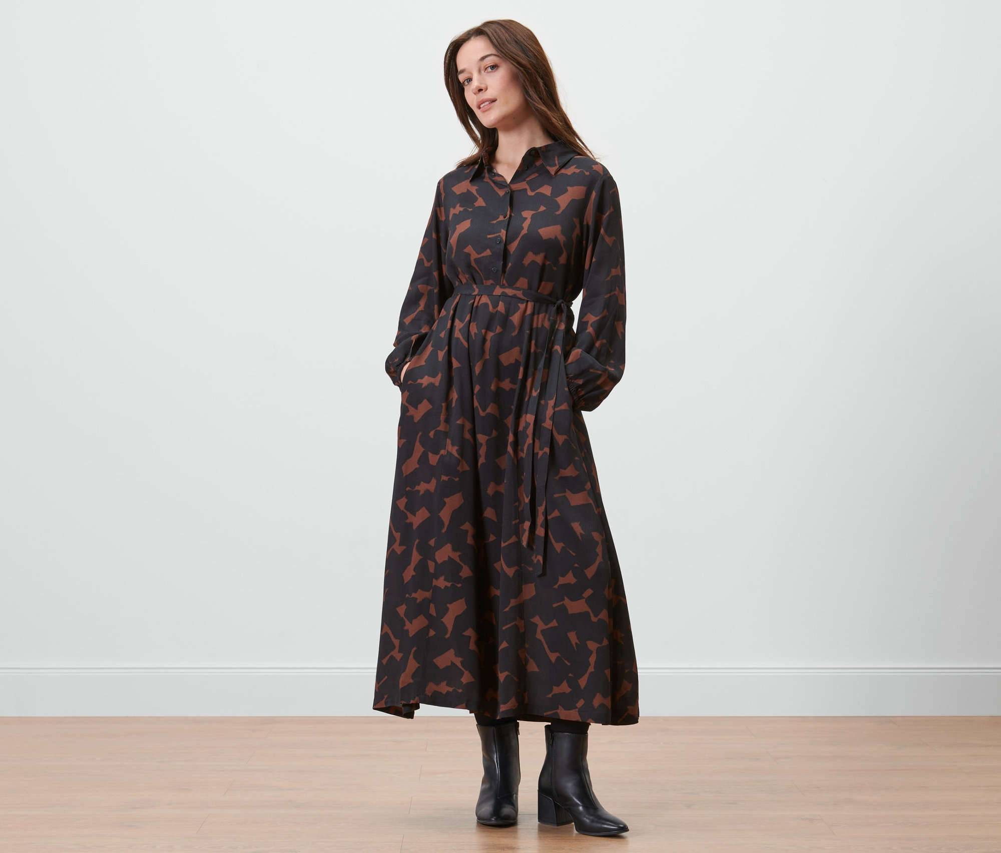 Frau posiert in einem bedruckten Webkleid.