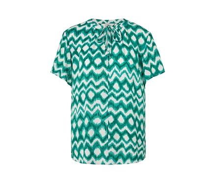 Weisse Tunika-Bluse mit grünem Muster.