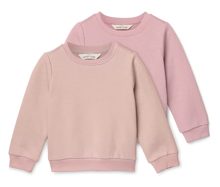 Zwei rosafarbene Kinderpullover liegen übereinander.