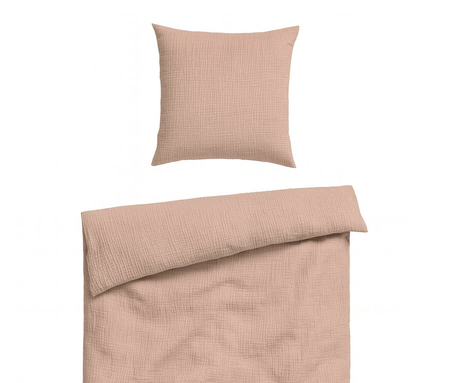 Nahaufnahme von korallfarbener Bettwäsche mit Kopfkissen und Bettbezug.