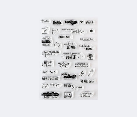 Ein Stempel-Set »Unbedingt merken« mit verschiedenen Motiven, einschließlich Schriftzüge und Bilder, angeordnet auf einem weißen Hintergrund.