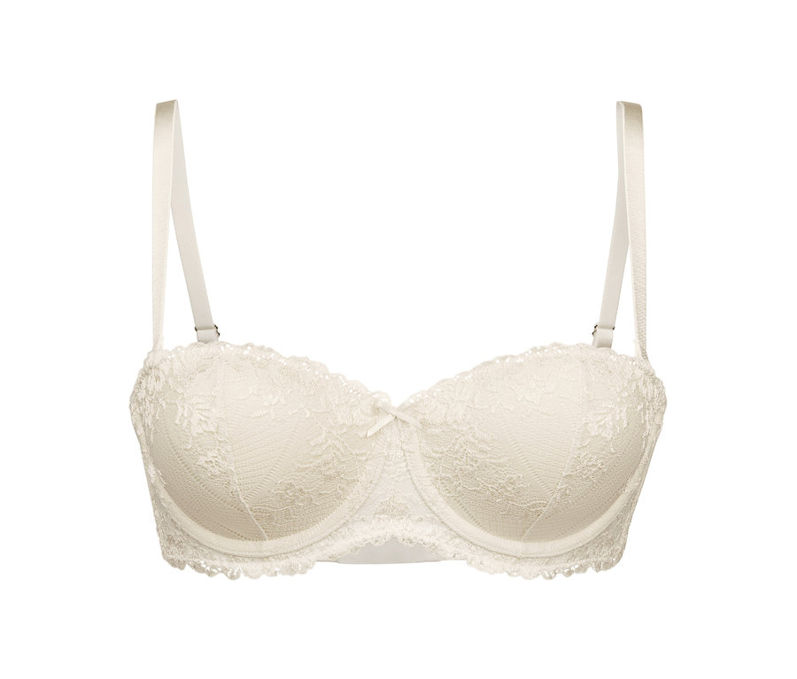 Ein cremefarbener Multistyle-BH mit Spitze und Schleife in der Mitte.
