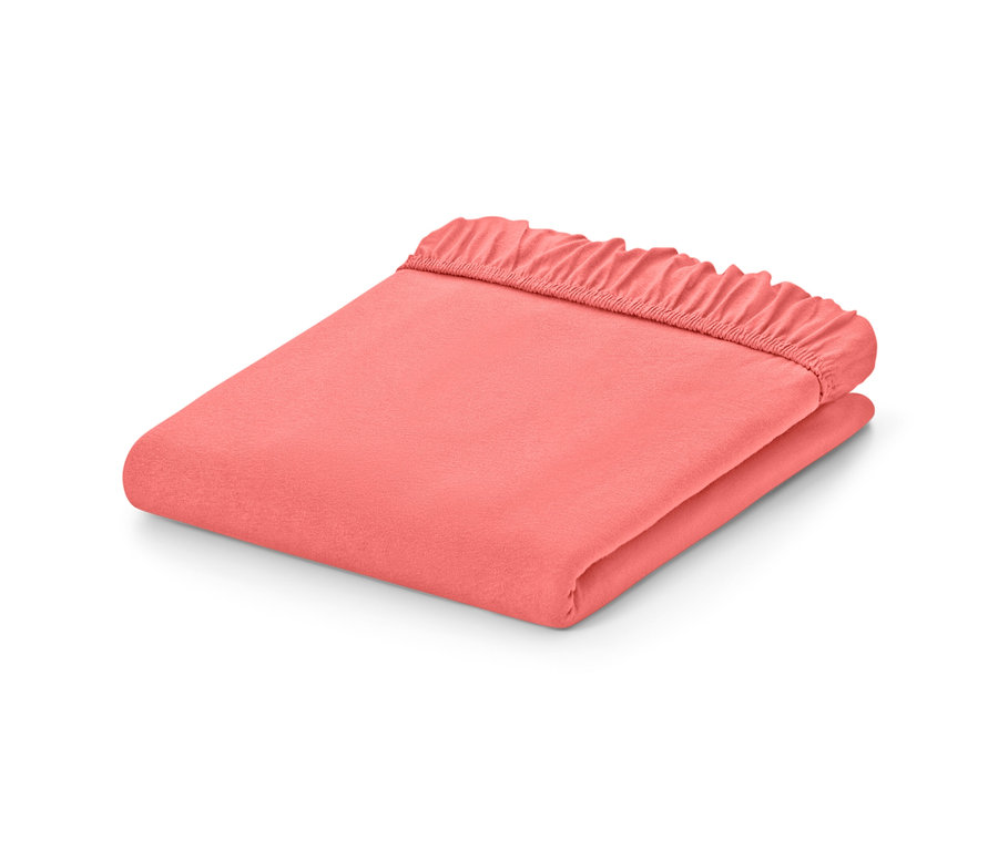 Gefaltete Jersey-Spannbettlaken in Papaya in verschiedenen Größen auf weißem Hintergrund.