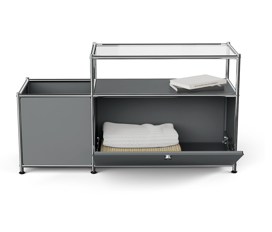 Grauer Schrank mit offener Schublade, weißer Decke und Buch oben.