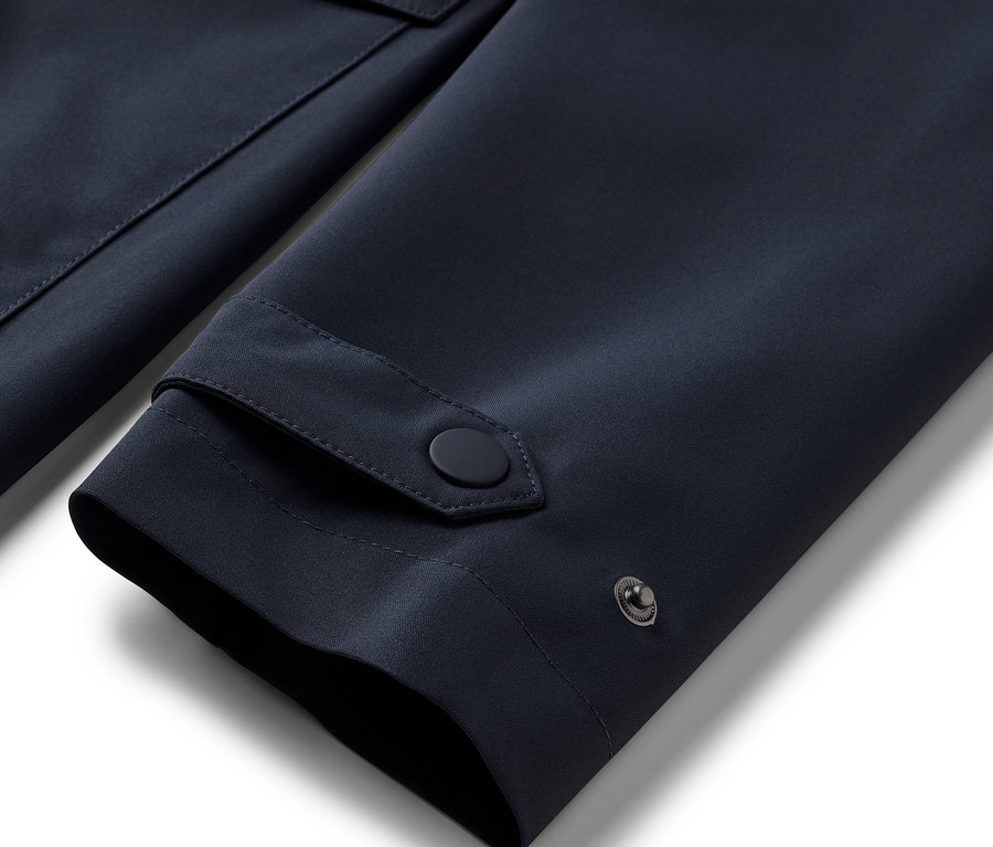 Detailansicht Ärmel eines blauen Regentrenchcoats.