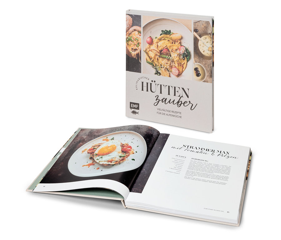 Aufgeschlagenes Kochbuch mit Rezept für "Strammer Max" und Buch "Kulinarischer Hüttenzauber" dahinter.