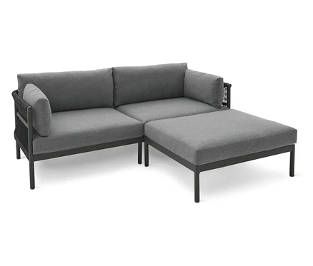 Graues Ecksofa mit Ottomanen auf einem weißen Hintergrund.