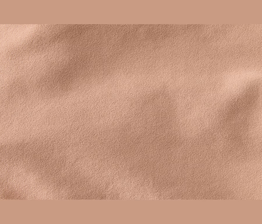 Helles, beiges Stoffgewebe mit feiner Textur und leichten Falten.