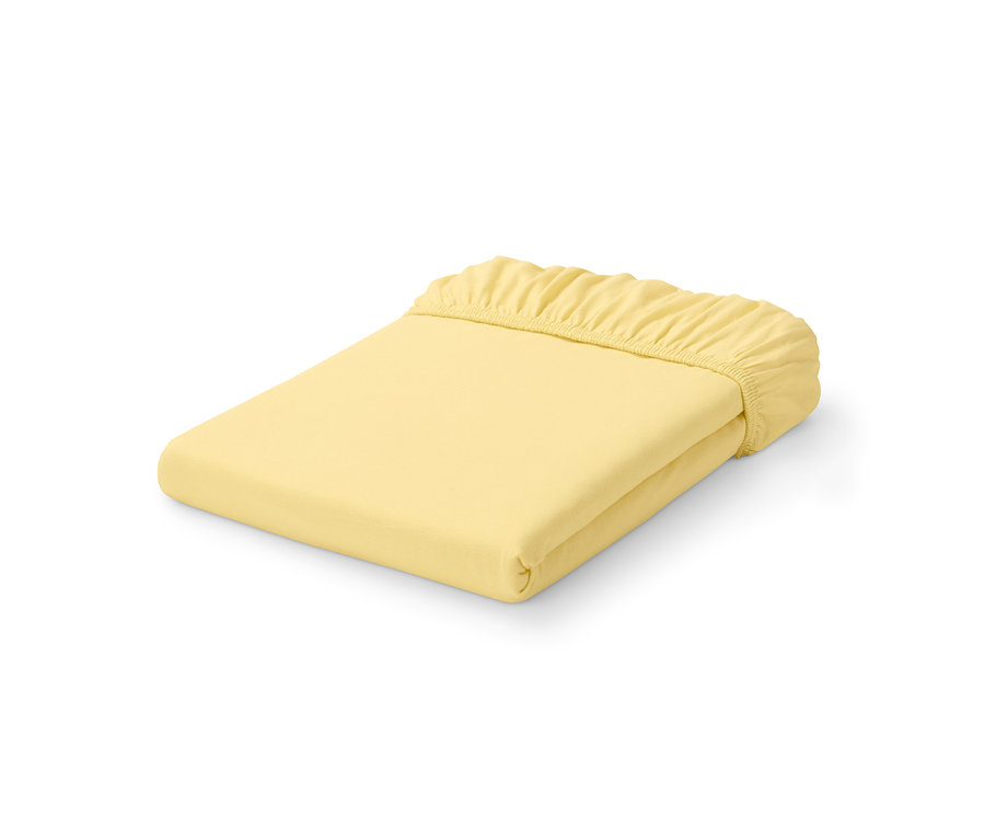 Gefaltetes gelbes Premium-Jersey-Spannbettlaken.
