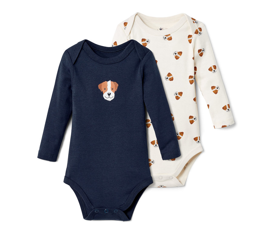 Zwei Babybodys: Ein dunkelblauer Langarmbody mit Hundekopf-Motiv und ein cremefarbener Body mit Allover-Hundekopf-Print.