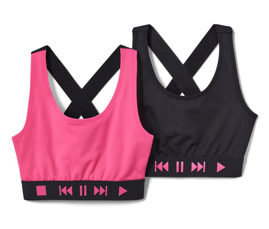 Zwei Kinder-Sportbustiers, eins in Pink und eins in Schwarz, beide mit Playback-Symbolen am Bund.