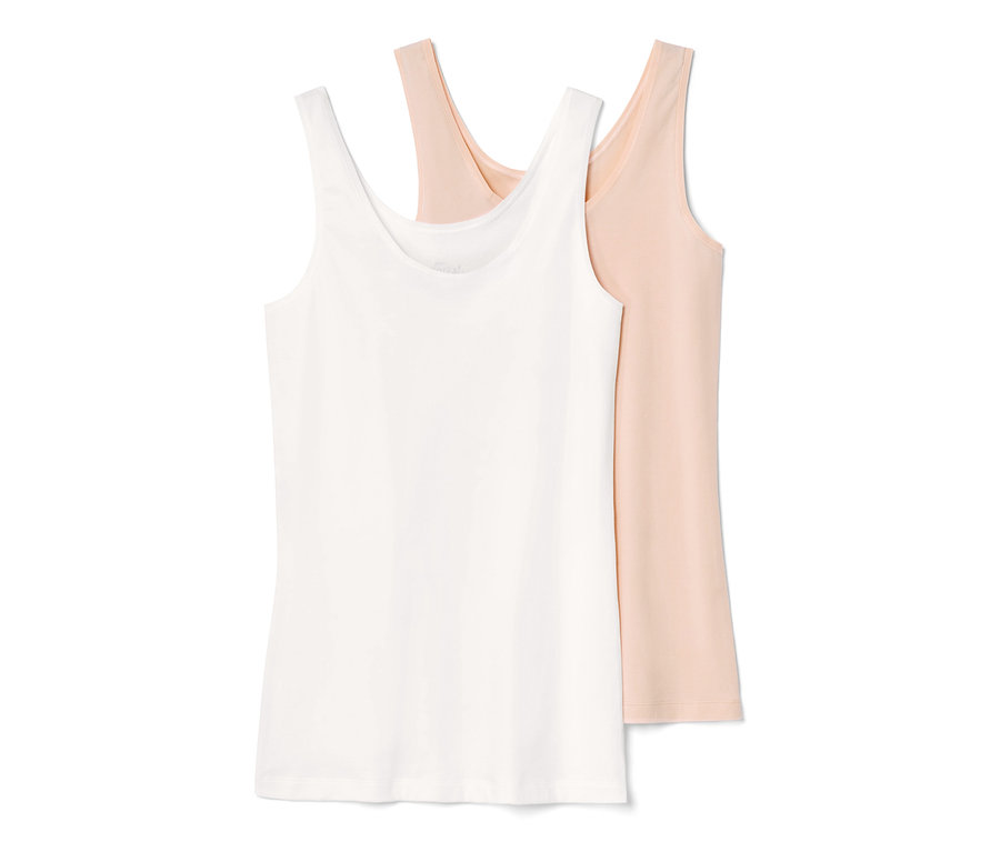 Zwei Hemdchen, eines in Weiß und eines in Rosa.