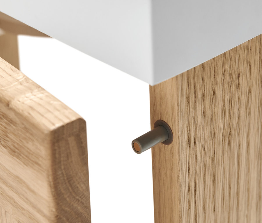 Detailansicht eines Gästewaschbeckens mit Unterschrank, dessen Tür geöffnet ist.