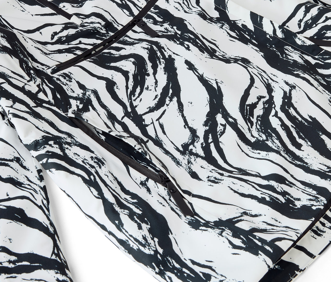 Detailaufnahme eines weißen Pyjamas mit abstraktem, schwarzem Muster und Paspelierung.