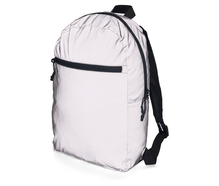 Silberner Rucksack mit schwarzen Akzenten und Reißverschlüssen, stehend auf einem weißen Untergrund.