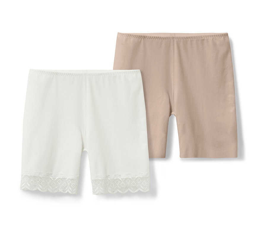 Zwei Radler-Shorts, eine weiße mit Spitze und eine beige.