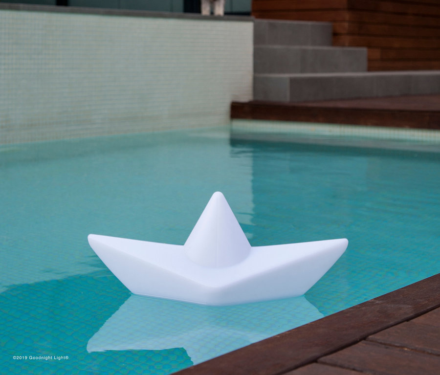 Eine Goodnight Light LED-Leuchte »Boot« schwimmt im Pool.