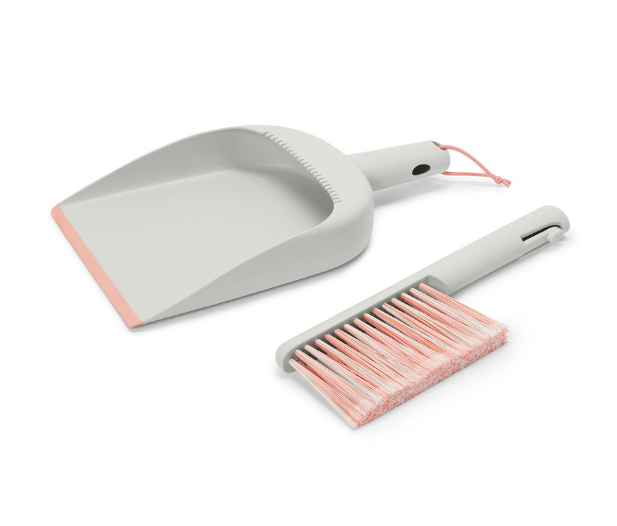 Grauer Handkehrer und Schaufel mit rosa Details.