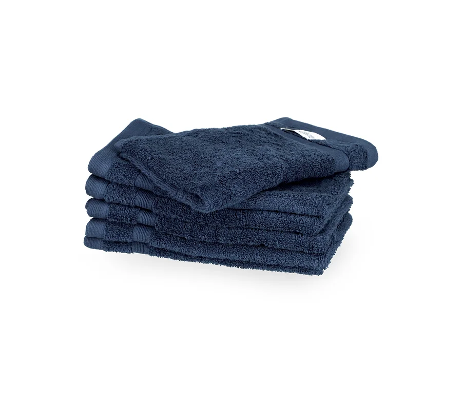 Fünf gefaltete, blaue SCHÖNER WOHNEN-Kollektion Gästehandtücher »Cuddly« liegen gestapelt, das oberste mit Etikett.
