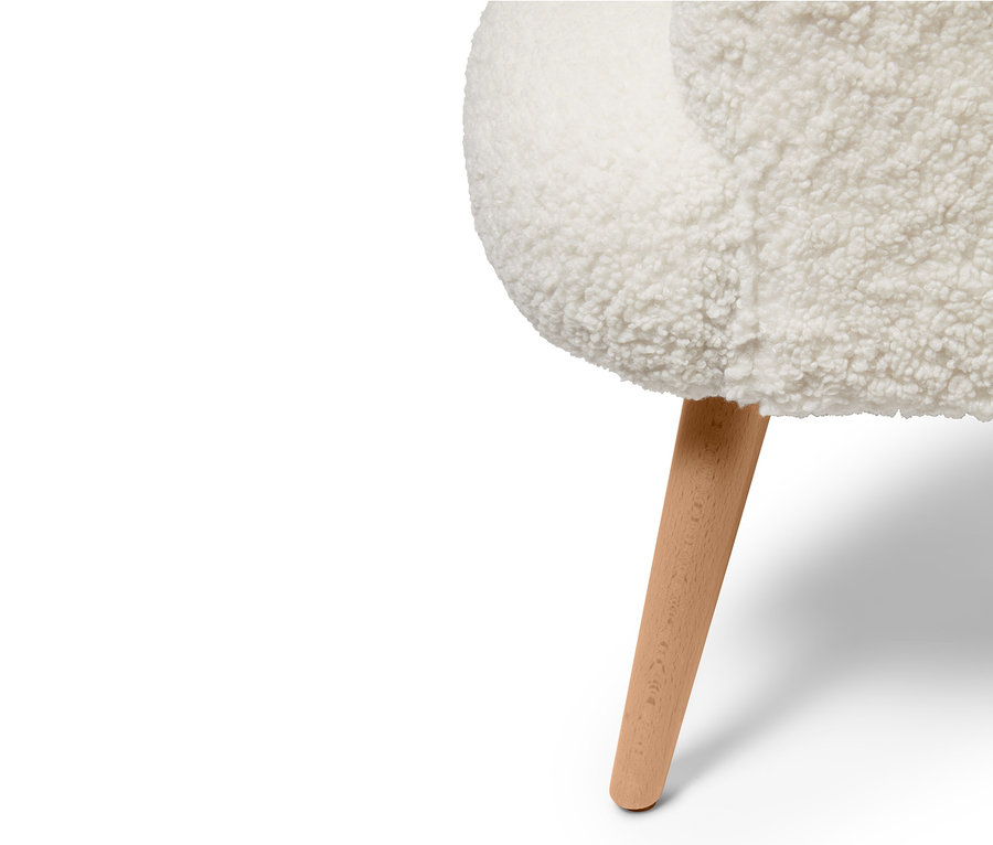 Detailansicht eines Teddy-Sessels mit Holzbein.