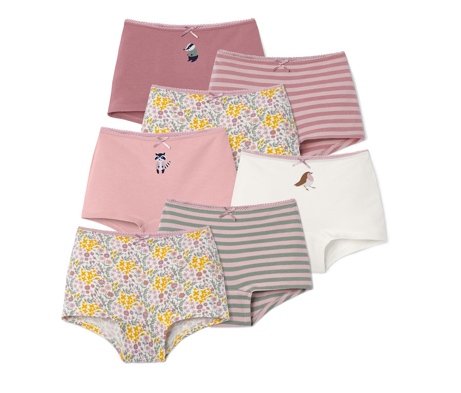 Sieben Mädchen-Pantys in verschiedenen Farben und Mustern, mit Blumen-, Streifen- und Tiermotiven.