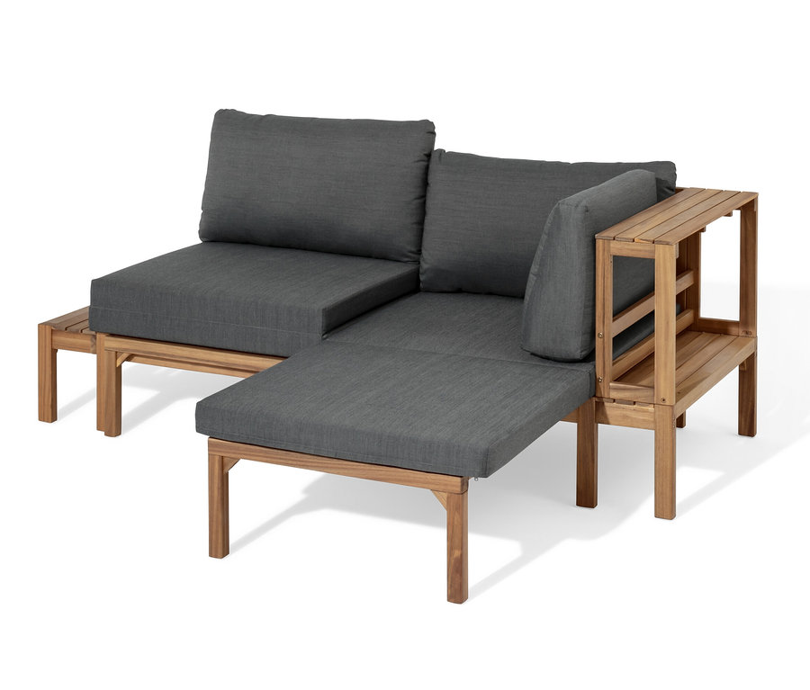 Flexible Lounge-Ecke »Tinus« mit ausziehbaren Fußlehnen und grauen Kissen.