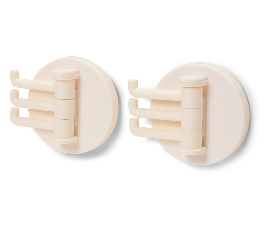 Zwei cremefarbene, drehbare Haken auf weißem Hintergrund.