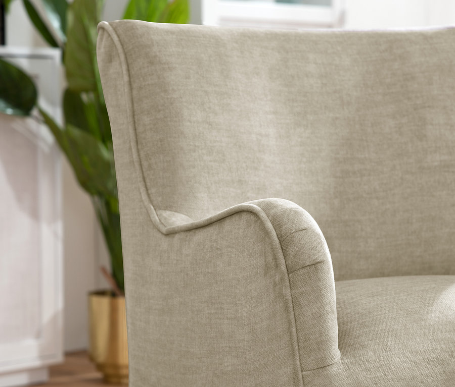 Detailansicht eines beigen Polsterstuhls mit Armlehne »Leopold«.