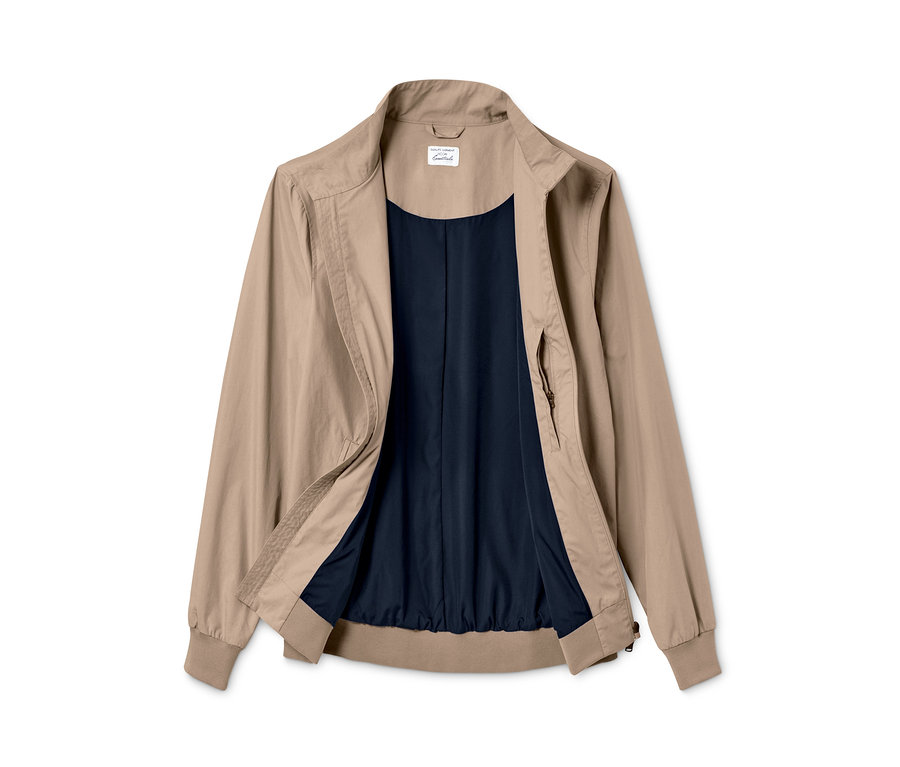 Geöffnete beige Blousonjacke mit dunkelblauem Futter.