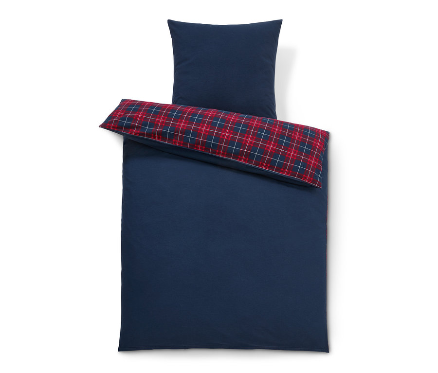 Blaue Biber-Bettwäsche in Normalgröße mit kariertem Kissen.