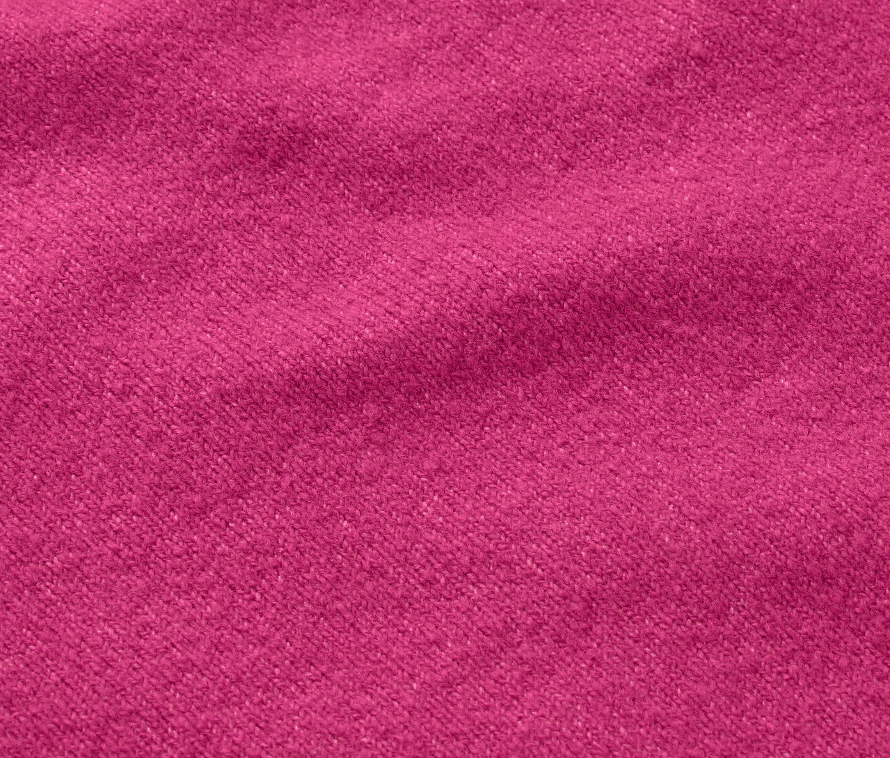 Nahaufnahme einer Stofftextur in Fuchsienrosa.