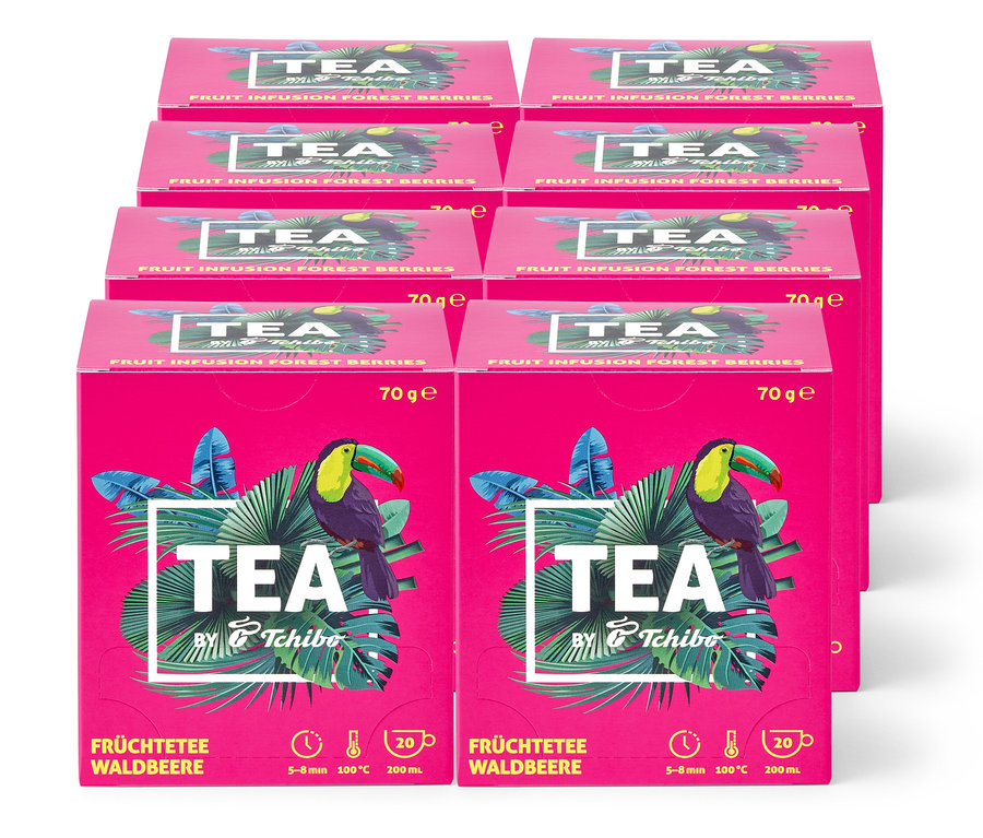 Stapel von rosa Tee-Boxen "Früchtetee Walbeere" mit Tukan und tropischen Blättern, Teil des Geschenksets "Kleine Auszeit".