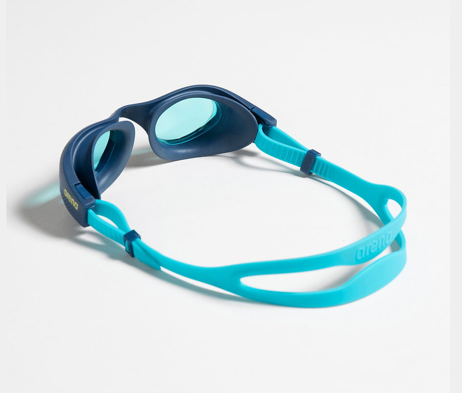 Eine blau-türkise Arena Kinder-Schwimmbrille liegt auf einem weißen Hintergrund.