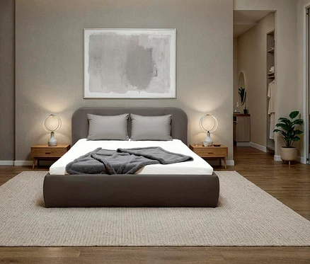 Graues DOMO collection Polsterbett, 180 x 200 cm, mit zwei Kissen und einer grauen Decke auf einem beigen Teppich.