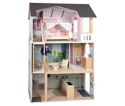 Puppe steht im small foot Puppenhaus »Traumvilla XL«.
