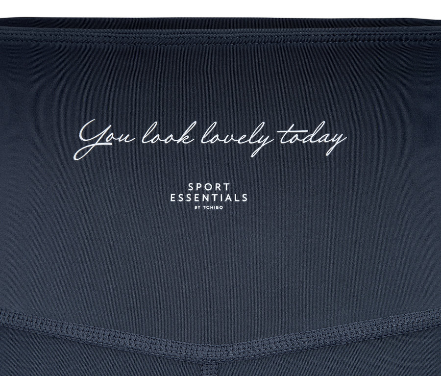 Detailansicht einer blauen »Soft Touch« Sporttight mit Schriftzug.