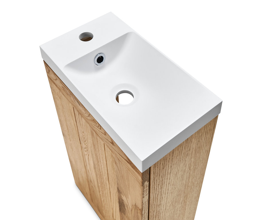 Draufsicht auf ein weißes Gästewaschbecken mit Unterschrank.