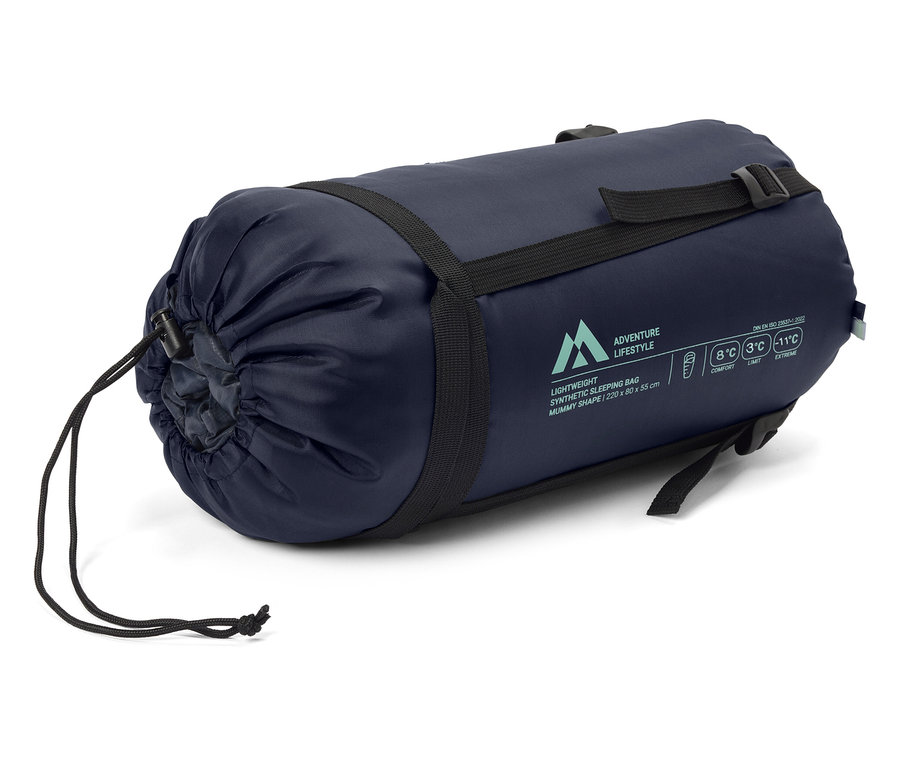 Ein marineblauer Schlafsack ist mit schwarzen Riemen verschnürt.
