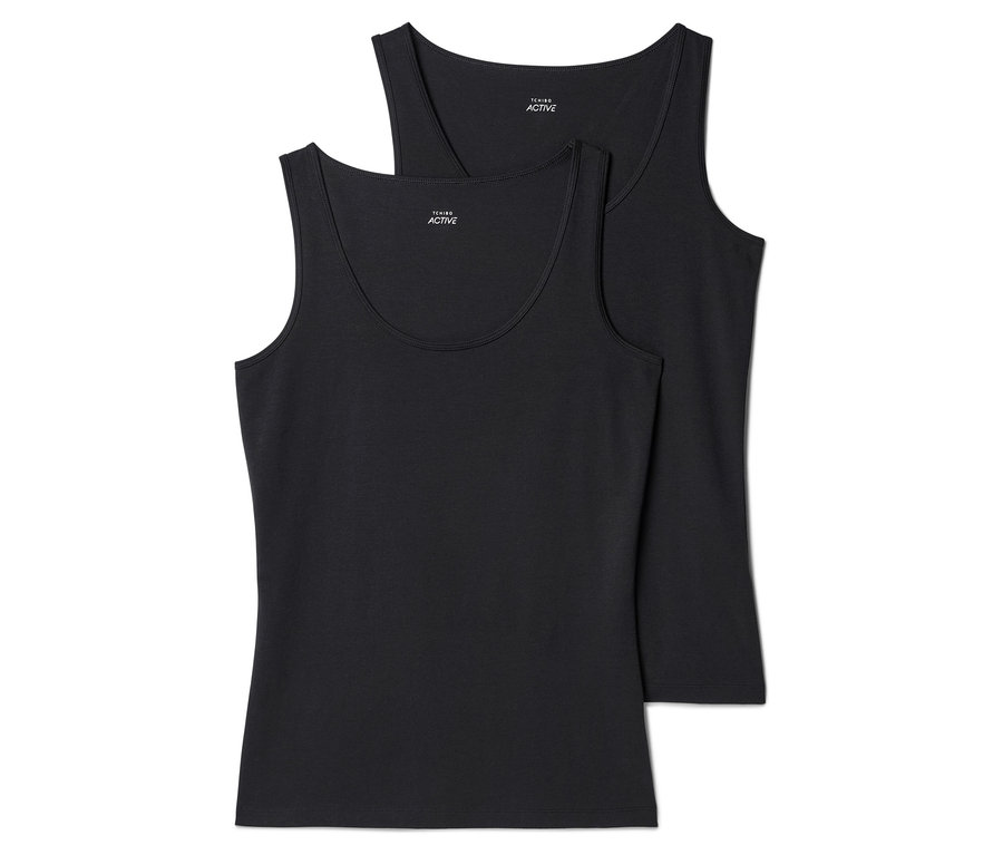 Zwei schwarze, ärmellose Tanktops liegen übereinander, wobei das obere Tanktop teilweise vom unteren verdeckt wird.