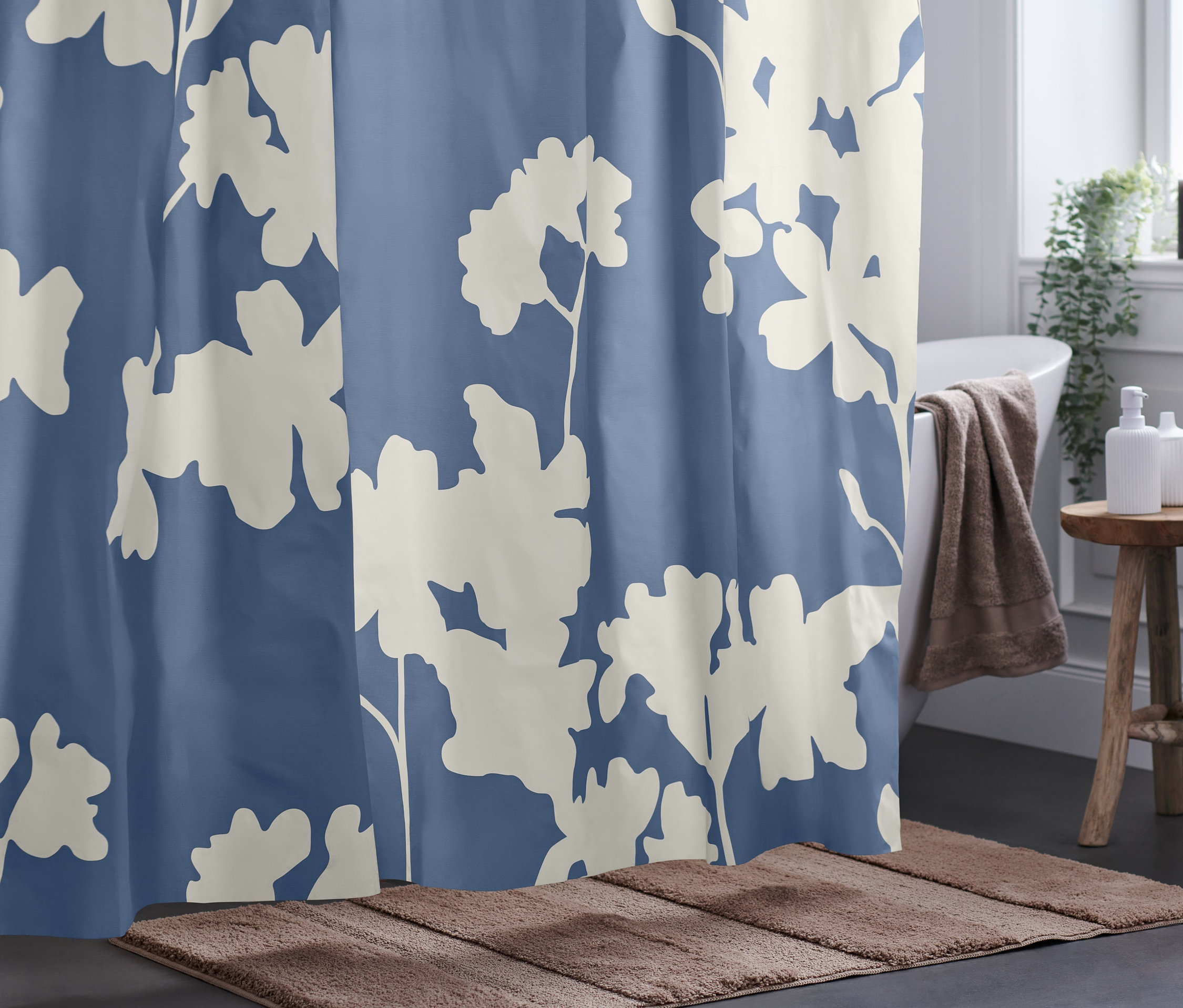 Blauer Duschvorhang mit großen weißen Blumen.