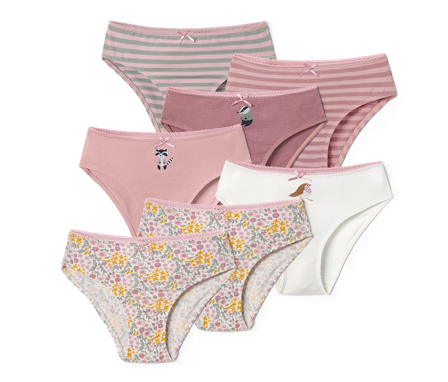 Sieben Mädchenslips in verschiedenen Farben und Mustern, darunter Streifen, Blumen und Tiere.