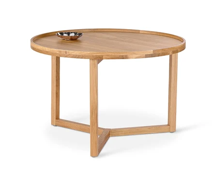 Runder Couchtisch aus Holz mit einer Schale darauf.