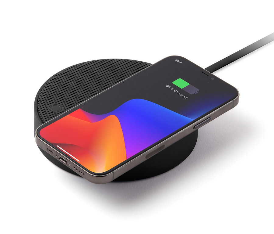 Ein Mobiltelefon wird auf einem schwarzen, kabellosen Ladegerät geladen. Auf dem Ladegerät ist das Lexon »OSLO ENERGY+« zu sehen.