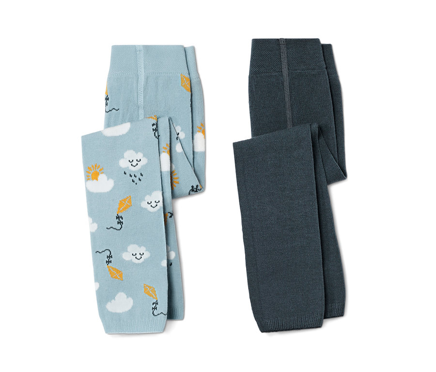 Zwei Kleinkinder-Strickleggings, eine hellblau mit Wolken- und Drachenmuster, die andere dunkelblau.