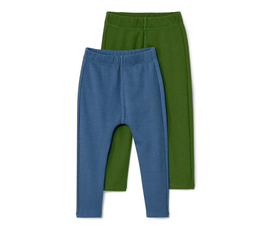 Zwei Babyhosen, eine blaue und eine grüne.