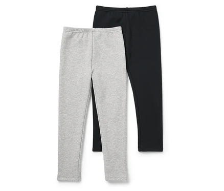 Zwei Leggings, eine graue und eine schwarze, liegen nebeneinander auf einem weißen Hintergrund.