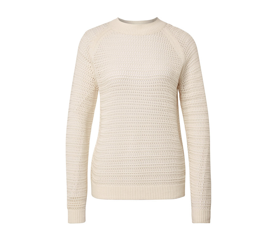 Ein cremefarbener Pullover in Pointellestrick vor einem weißen Hintergrund.